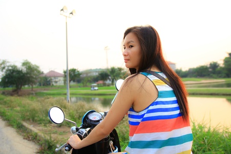Portrait of smiling girl on scooter - Outdoor on street  Retro shot  Fashion art photoの写真素材