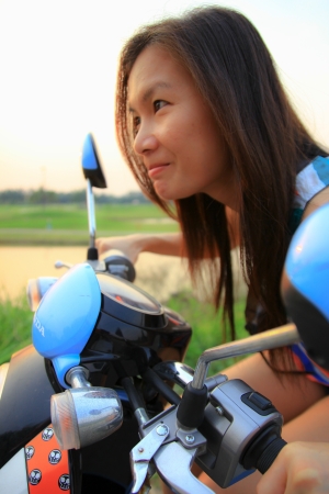 Portrait of smiling girl on scooter - Outdoor on street  Retro shot  Fashion art photoの写真素材