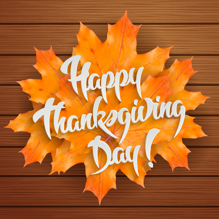 Happy Thanksgiving Day - hand lettering greeting card with maple leaves on wooden backgroundのイラスト素材