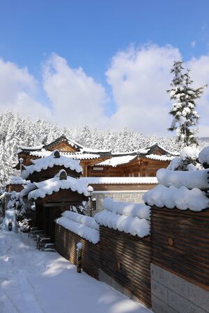 Snow covered Korean traditional stone wall and roof tile. Woljeongsa buddhist temple, Gangwon-do, Koreaの写真素材