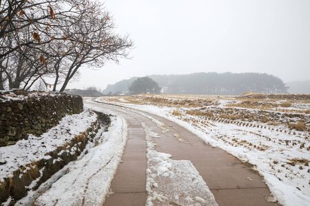 Winter in Korea, snowy countryside landscape Oeam Folk Village.の写真素材