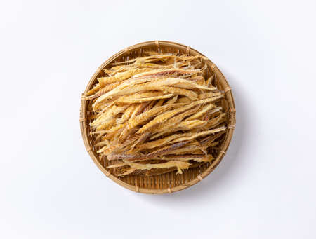 Thinly sliced dried pollack in a traditional basket viewed from aboveの写真素材