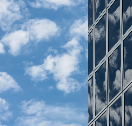 Cloudy sky reflected in modern buildingの写真素材