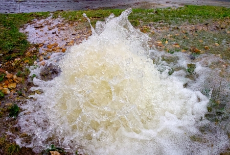 more water being wasted by old leaky pipesの写真素材