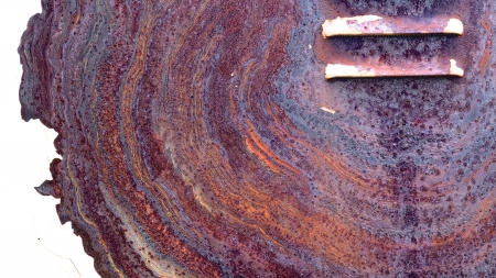 Intricate colorful rust pattern on a painted surface in need of repair, with ventsの写真素材