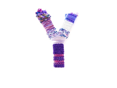 the letter y created with brightly coloured knitting yardの写真素材