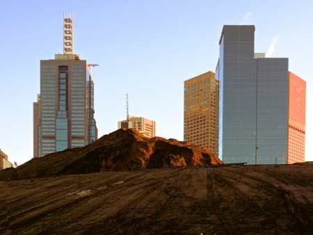 New building excavation with Melbourne city skyscrapers behindの写真素材