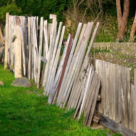 broken wooden fence in desperate need of repairの写真素材