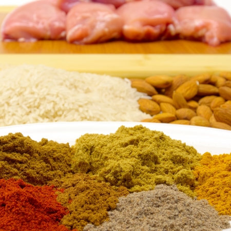 varied ingredients to make chicken korma including spices almonfs and riceの写真素材