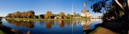 panorama of melbourne on a sunny autumn day with yarra river in foregroundの写真素材
