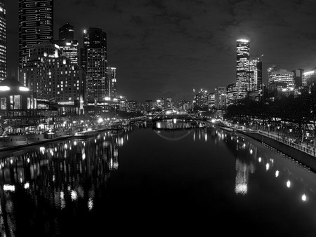 black and white melbourne city reflected in the yarra river at nightの写真素材