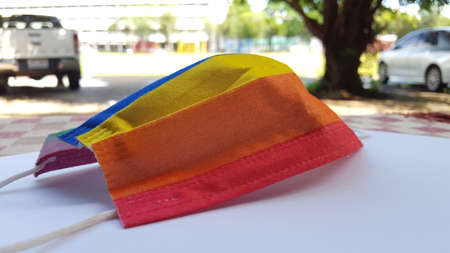 Yellow orange and red mask on a white sheet. A concept is for pride month and LGBTQIA communities around the globe.の写真素材