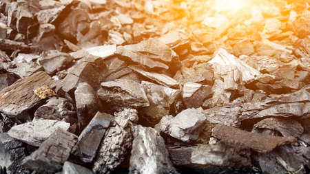 Plenty of Black wooden charcoal chips with the sunlightの写真素材
