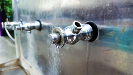 Distorted faucet of the water cooler tankの写真素材