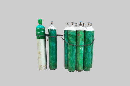 Green and scratches oxygen tanks tied with chainsの写真素材
