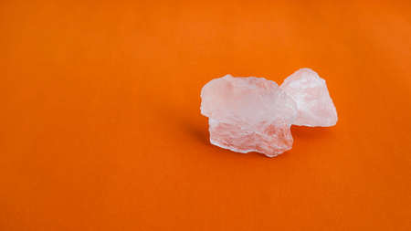 Isolated clear alum cubes on orange background concept for spa and body deodorant industrialの写真素材