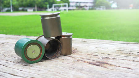Used copper empty bullet shells on wood plankの写真素材