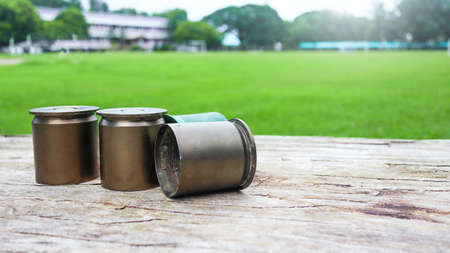 Used copper empty bullet shells on wood plankの写真素材