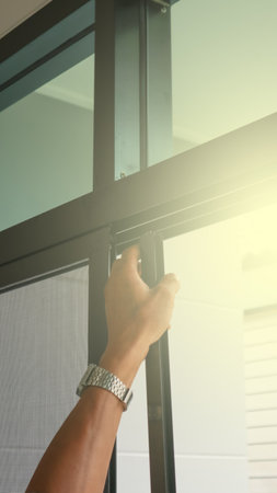 Technician inspects a window frame which is new installed a mosquito wire screen