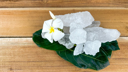 frangipani flower and ice cubes on wooden table background.の写真素材