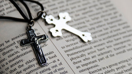 Cross and rosary on the Bible, closeup of photoの写真素材