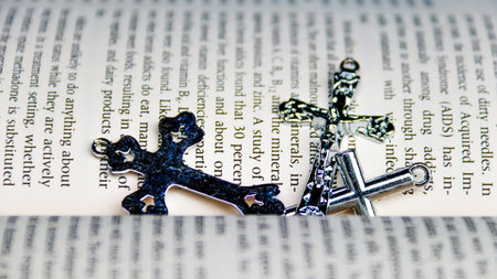 Two silver crosses on the book. Religion concept. Selective focus.の写真素材