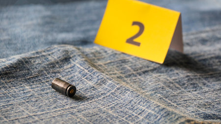 9mm bullet and paper note number 2 on jeans background, shallow depth of fieldの写真素材