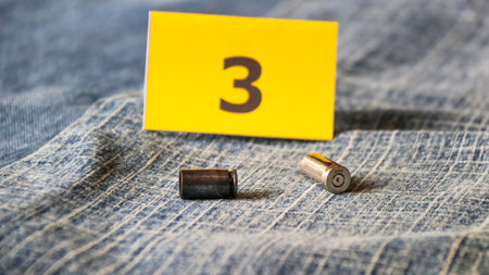 9mm bullet and yellow paper with the number 3 on jeans backgroundの写真素材