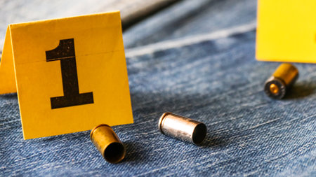 Pistol bullet shells on blur blue jeans and number one display in background, concept for criminal and investigation. soft focusの写真素材