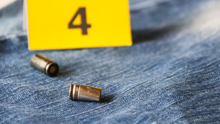 Pistol bullet shells on blur blue jeans and number displays in background, concept for criminal and investigation. soft focusの写真素材
