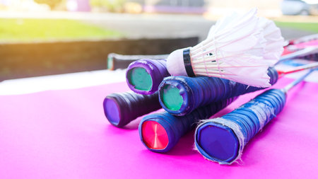 Badminton racket handles and shutter cocks on pink backgroundの写真素材