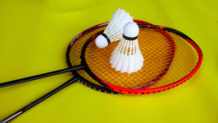 Badminton shutter cocks were put on the racket with yellow backgroundの写真素材