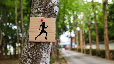 Paper board sign with graphic of running woman with blurred backgroundの写真素材