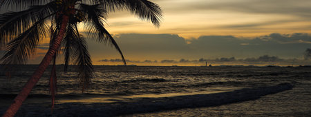 View of the sea and the beach under the dark evening sunlightの写真素材