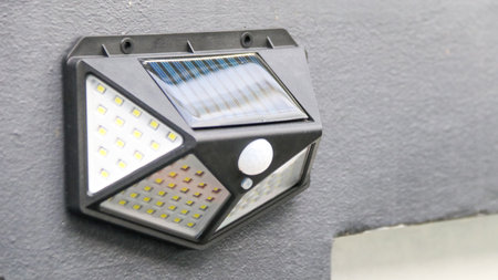 Small solar cell light installed on the fence in patio to provide light and decorate the patio at nightの写真素材