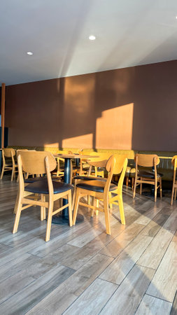 Coffee tables and chairs in the coffee shop under the morning sun light soft and selective focusの写真素材