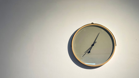 Clean modern clock hanging on the wall in the local coffee shop soft and selective focus