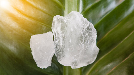 White alum cubes or Potassium alum on green leaf chemical compound substance concept of beauty spa...