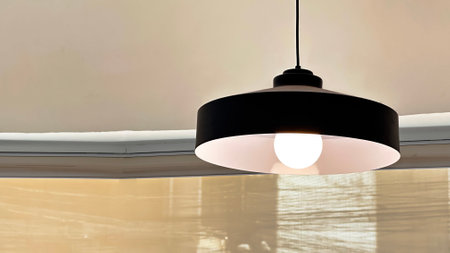 View of dark round traditional ceiling lamp hanging from the ceiling in coffee shopの写真素材