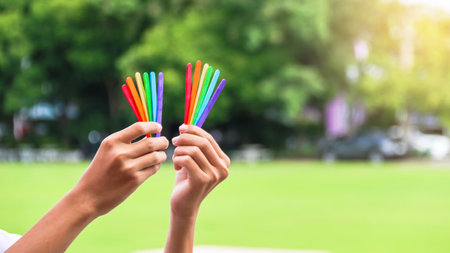 Close up of colorful ice cream strips holding in hands concept to enhance LGBT communities around the worldの写真素材