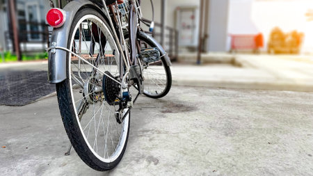 Close up parts of old school dark brown bicycle parked in local houseの写真素材