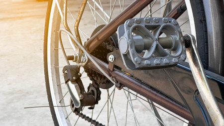 Close up parts of old school dark brown bicycle parked in local houseの写真素材