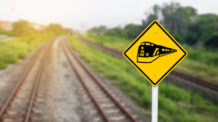 Train warning sign to warn people when crossing the railsの写真素材