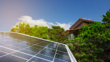Solar panels set against a blurred background, emphasizing the concept of using solar energy for homes in remote areas. The image highlights the practicality and sustainability of solar power.の写真素材