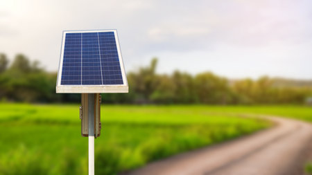 Solar panels installed beside the roadside, powering street lights for nighttime illuminationの写真素材