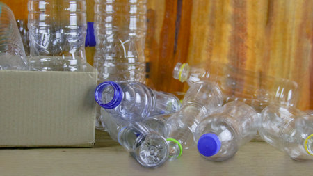 Waste plastic bottles on wooden background waiting for recycling