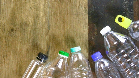 Waste plastic bottles on wooden background waiting for recycling