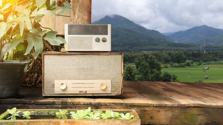 Image of almost rotten gray old fashion radio receivers on wooden planks floor.の写真素材