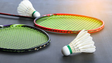 Badminton shuttlecocks with rackets on a dark background symbolizing the spirit of exercise and global competition the essence of athleticism and the pursuit of excellence in the sport.の写真素材