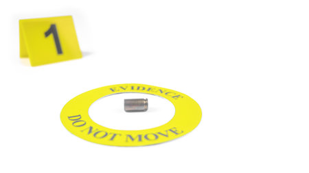 A spent bullet casing placed within a yellow circle, labeled with the text "Evidence, Do Not Move," with a blurred number 1 tag, set against a white background, concept of crime investigation.の写真素材